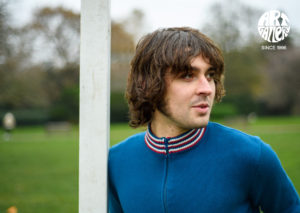 ART GALLERY CLOTHING SIXTIES MOD KNITWEAR Sailor blue, zip through funnel neck cardigan with sailor blue, red & off white striped neck, cuffs & waistband.