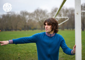 ART GALLERY CLOTHING SIXTIES MOD KNITWEAR Sailor blue, zip through funnel neck cardigan with sailor blue, red & off white striped neck, cuffs & waistband.